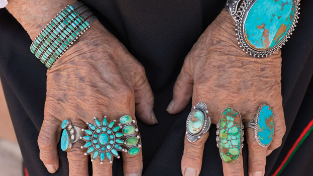 Photo of aged hands with turqouise jewelry, photo by Jason Ordaz